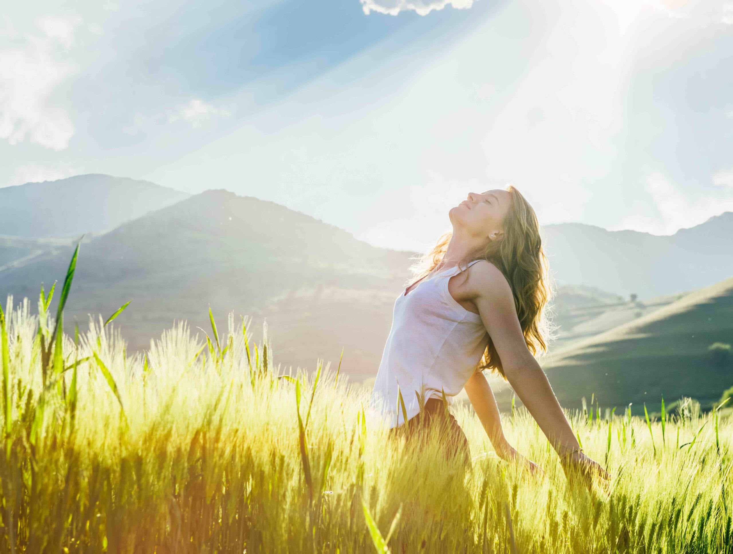 Young woman outdoor enjoying the sunlight young woman in the wheat field enjoying the sun